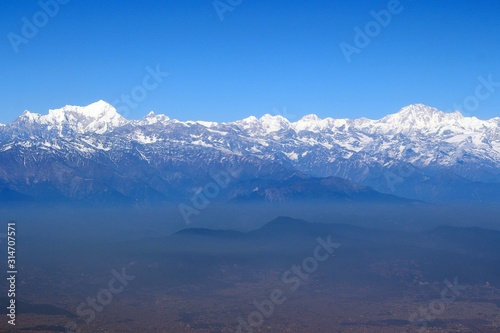 Scale of the Himalayas / Enormous of the Himalaya ranges above the cloud and layer of dust over Nepal