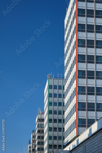 The facade of a modernist skyscrapers made of glass and aluminum in the center of Poznan. © GKor