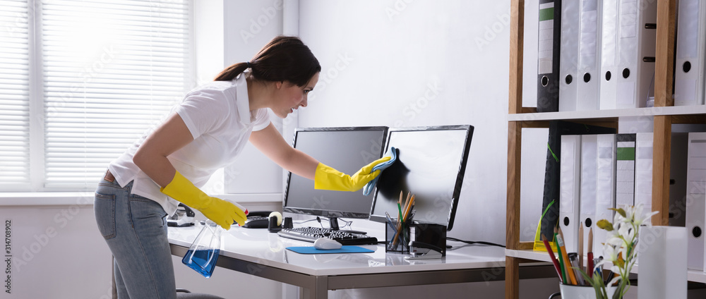 Woman Cleaning Computer In Office - obrazy, fototapety, plakaty 