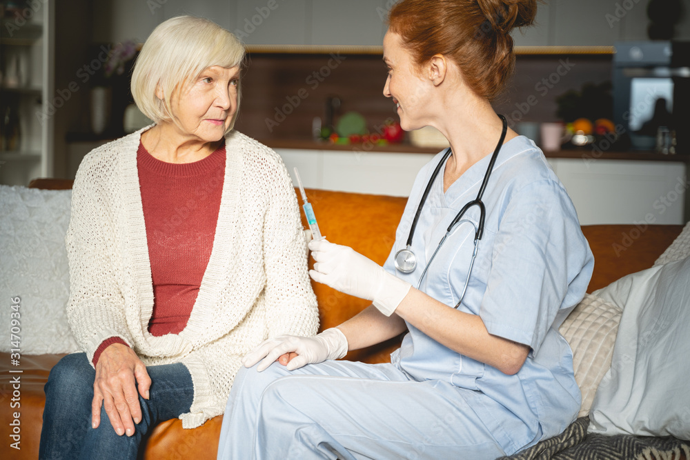 Serious blonde mature woman sitting near doctor Serious blonde mature woman sitting near doctor