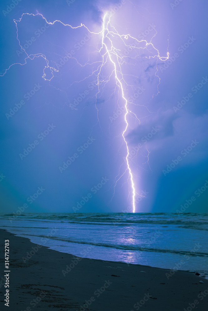 Long bright lightning strike over sea Long bright lightning strike over sea
