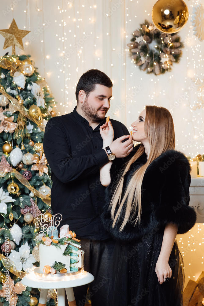 Family expecting a baby boy. Gender reveal cake with mandarins. Parents