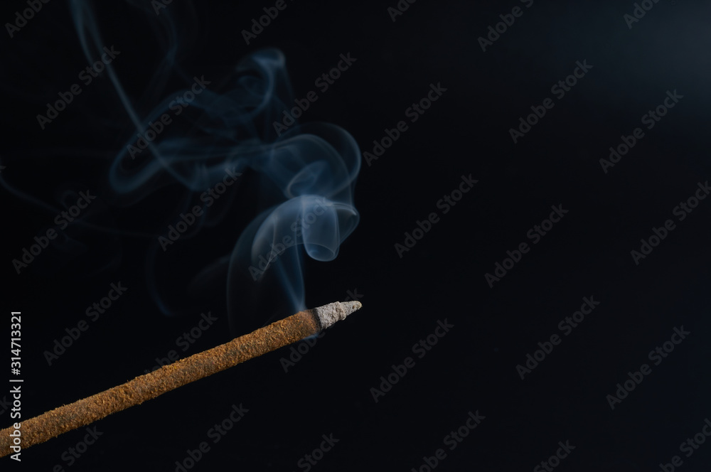 incense stick on a dark background close-up incense stick on a dark background close-up