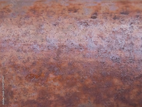 Rusted metal wall. Rusty metal background with streaks of rust.surface.