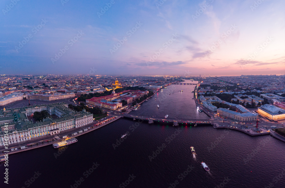 Beautiful aerial evning view in the white summer nights of St Petersburg, Russia, Hermitage at sunset, palace square, St. Isaac's Cathedral, The Alexander column, River Neva. shot from drone. Europe.
