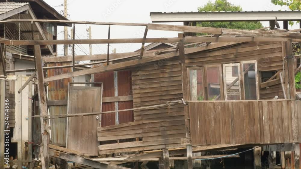 Crashed house on a canal, rim klong community right pan Crashed house on a canal, rim klong community right pan