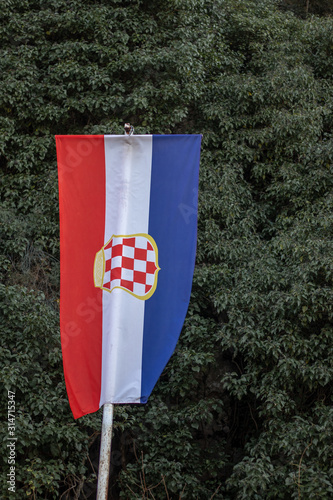 Flag of the Croatian Republic of Herzeg-Bosnia, displayed in croatian part of bosnia and herzegovina. Country split into serbian,muslim and croatian nationalities. photo