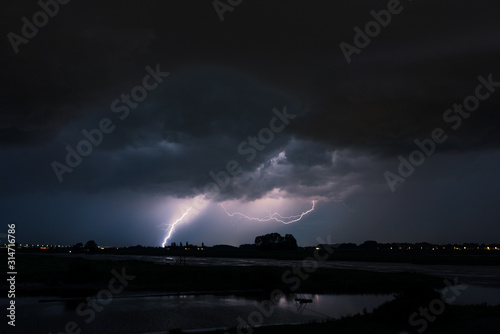 Stunning view of a storm with lightning in a river valley