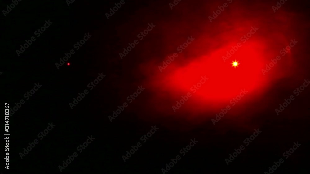Red rays of light from profile spotlights in the dark in a smoke blanket. Red rays of light from profile spotlights in the dark in a smoke blanket.