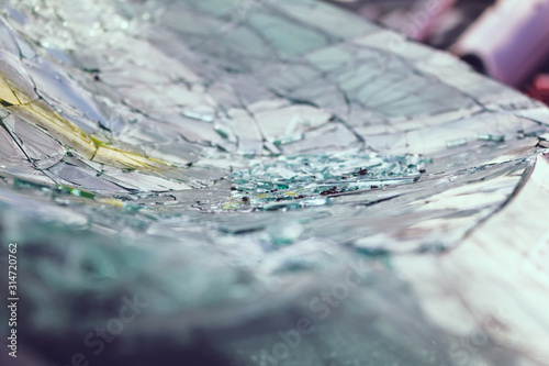 A closeup view of a broken and shattered car windshield.
