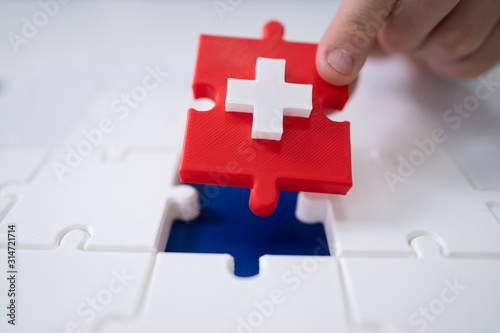 Man's Hand Solving Jigsaw Puzzle