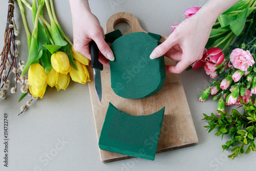 Woman shows how to make beautiful floral arrangement with tulip and carnation flowers