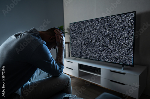 Man In Front Of Television With No Signal