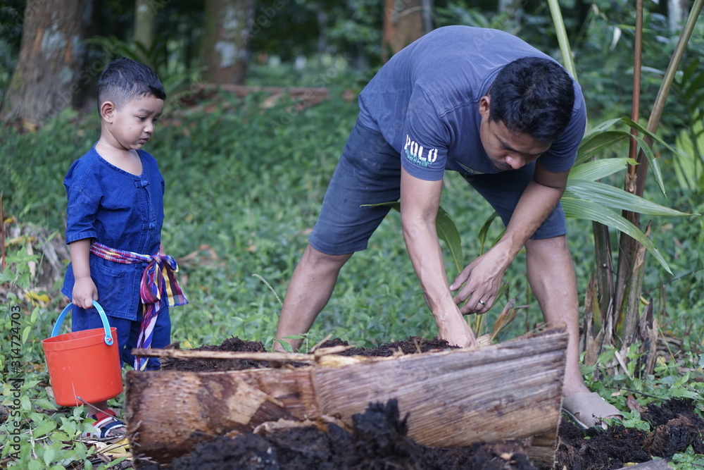 Happy baby child sitting on rural road, behind kid embrace life, dreamlike evening light, slow motion, innocent and pure love concept.                                                          