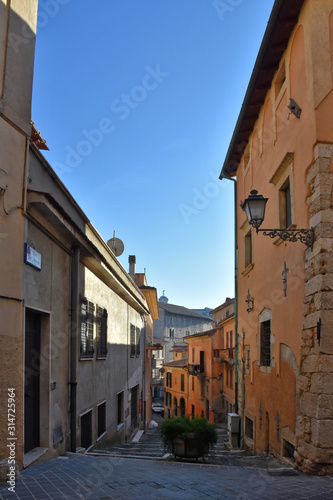 Alatri, Italy, 01/03/2020. A narrow street between the old houses of a medieval village © Giambattista