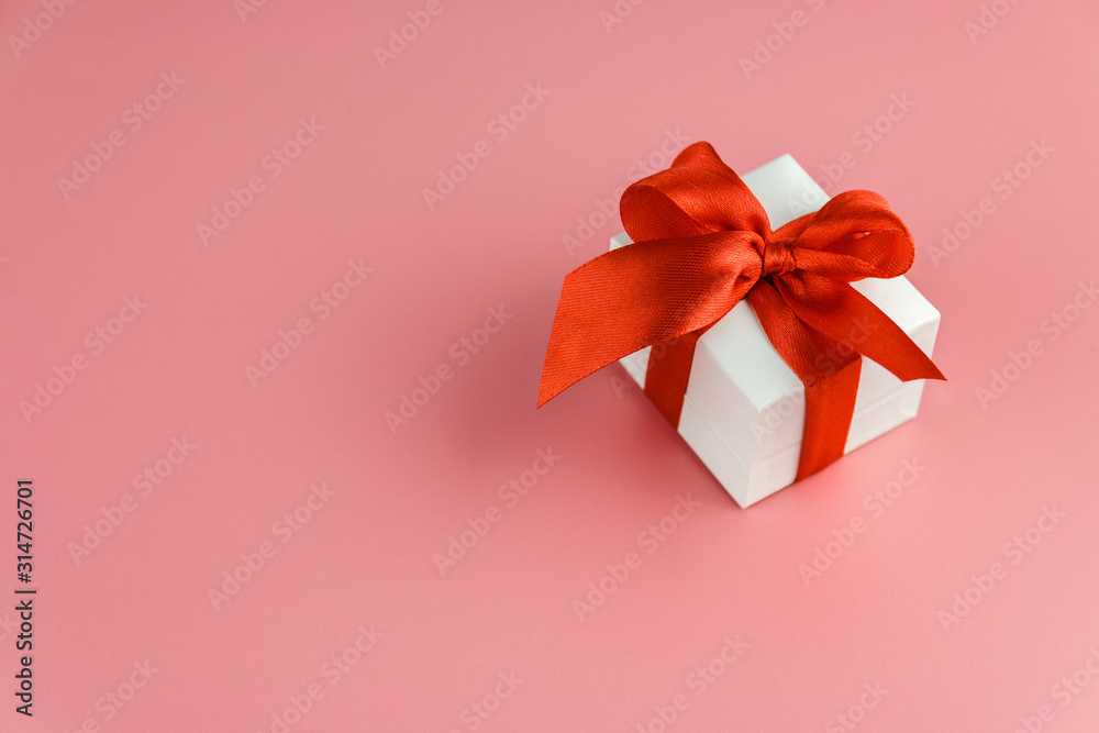 white gift box with red strap on colour background, engagement ring box white gift box with red strap on colour background, engagement ring box