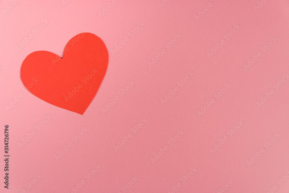 one red craft paper heart on pink background with copy space