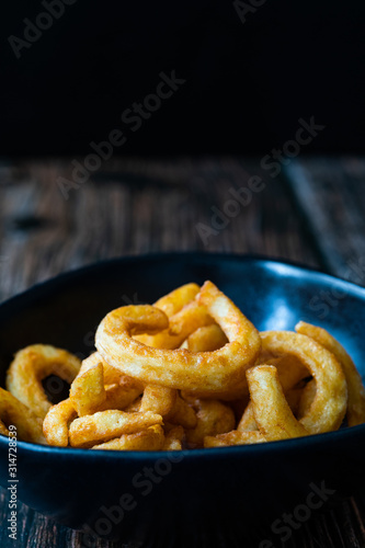 Spicy Seasoned Curly Fries Ready to Eat with Sauce.