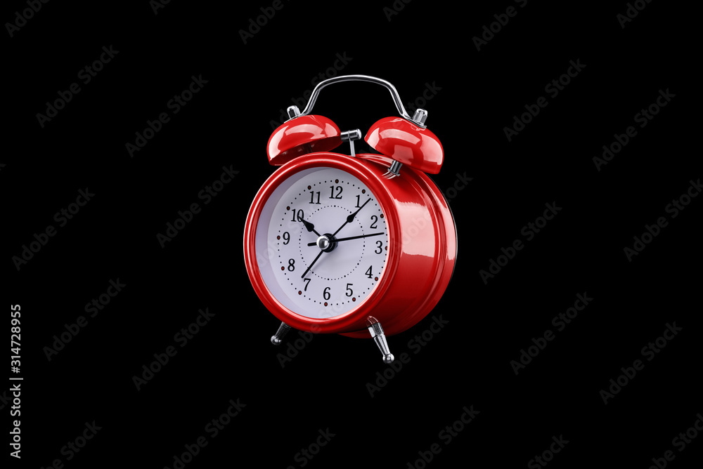 Red alarm clock close-up isolated on dark background. Red alarm clock close-up isolated on dark background.