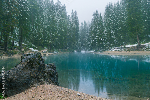 Winterlandschaft mit See und Wald im Nebel