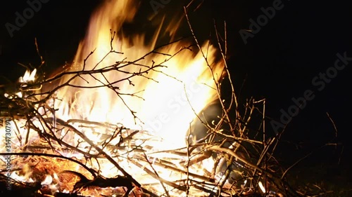 Burning fire. Bonfire. Closeup of flames burning on black background. Burning red hot sparks rise from large fire in the night sky. Bonfire burning trees at night. 