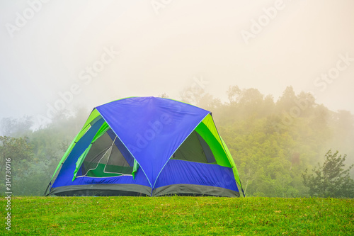 Camping Tents in Nature background with sunset scenic view at the forest.