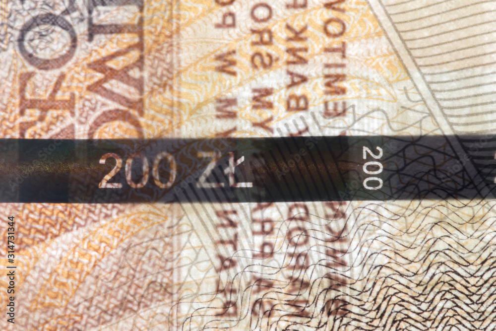 Naklejka premium Plastic security strip inside 200 PLN banknote. Security strip on Polish banknote created to prevent counterfeiters.