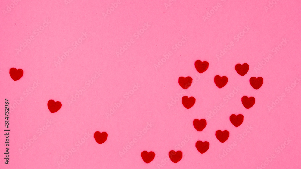 Small red hearts forming the shape of a large heart on a pink background.
