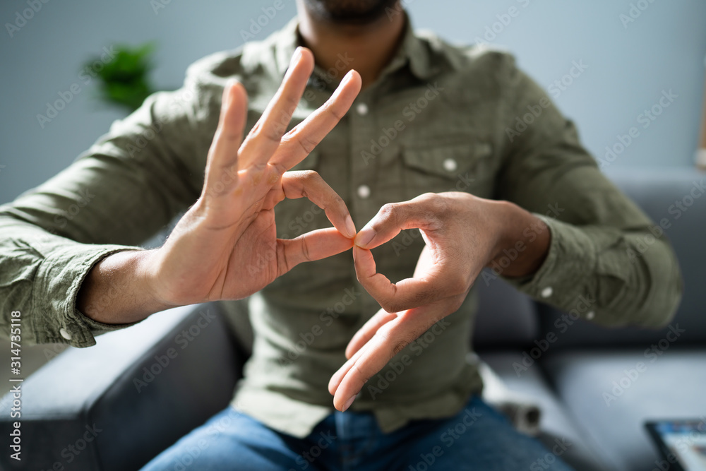 Fototapeta premium Man Using Sign Language To Communicate Against