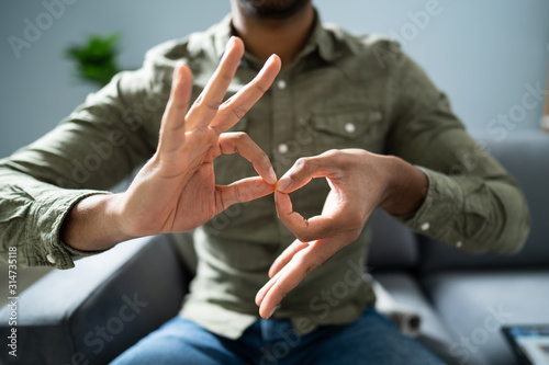 Man Using Sign Language To Communicate Against