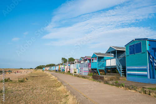 Colourful wooden beach huts facing the ocean at Whitstable coast,  Kent district England.