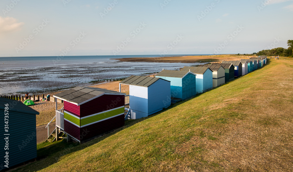 Colourful wooden beach huts facing the ocean at Whitstable coast, Kent district England. Colourful wooden beach huts facing the ocean at Whitstable coast, Kent district England.