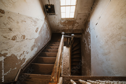 Old staircase in abandoned house filled with sand, Kolmanskop Ghost Town