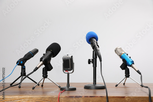 Set of different microphones on wooden table. Journalist's equipment