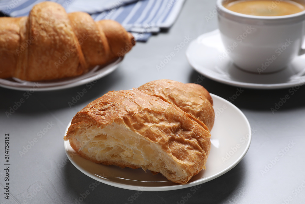 Tasty fresh croissant on light grey table, closeup Tasty fresh croissant on light grey table, closeup