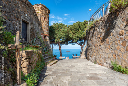 Walk pass to the mirador at Riomaggiore Castle. The wall, entrance and tower of the castle are at left.  Cinque Terre, Italy. photo