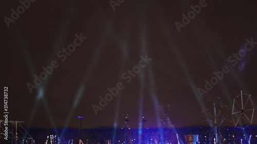 spotlights in the sky shine on stage rain
