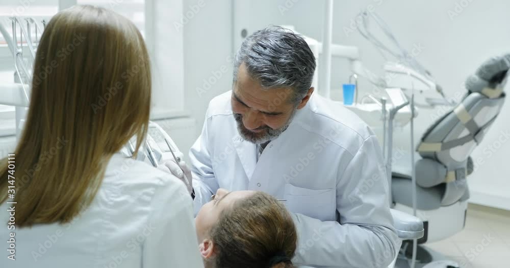 Dentist doing teeth examination. Dentist doing teeth examination.