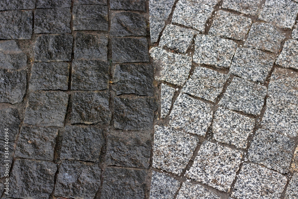 Rough texture of wet block pavement, Saint Malo old side-street Rough texture of wet block pavement, Saint Malo old side-street