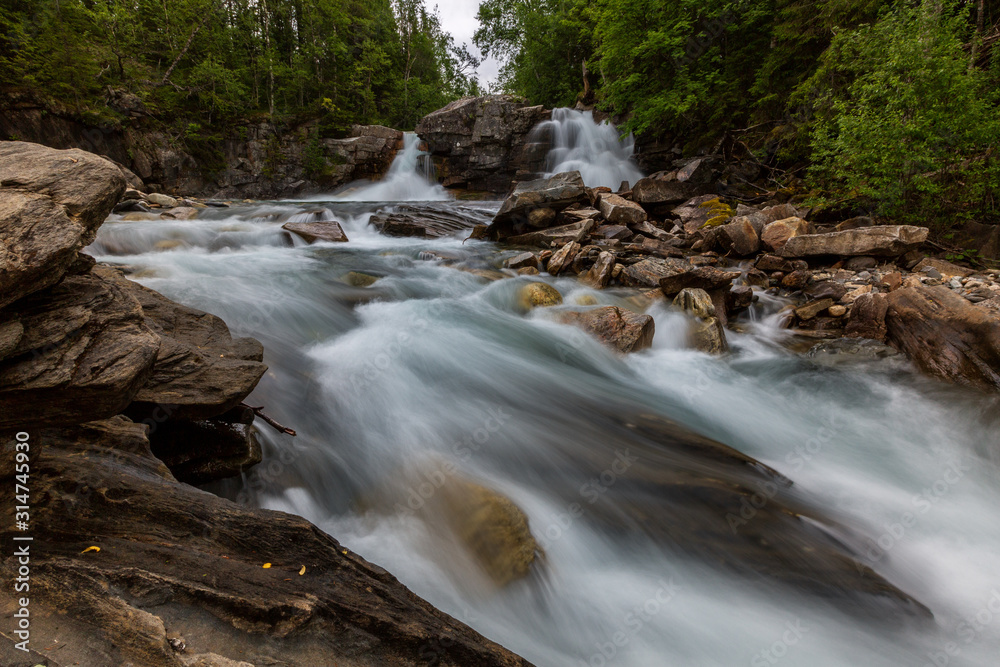 Beautiful stream with waterfall on background, long exposure Beautiful stream with waterfall on background, long exposure