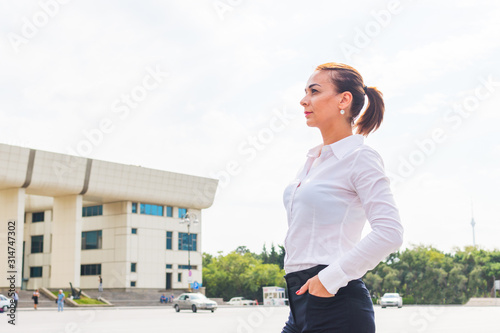 young successful business woman looking at the city