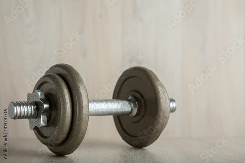 Iron dumbbell on a wooden floor