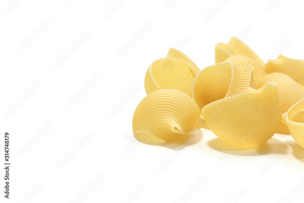 A lot of italian's raw pasta(macaroni) conchiglie on a white background A lot of italian's raw pasta(macaroni) conchiglie on a white background
