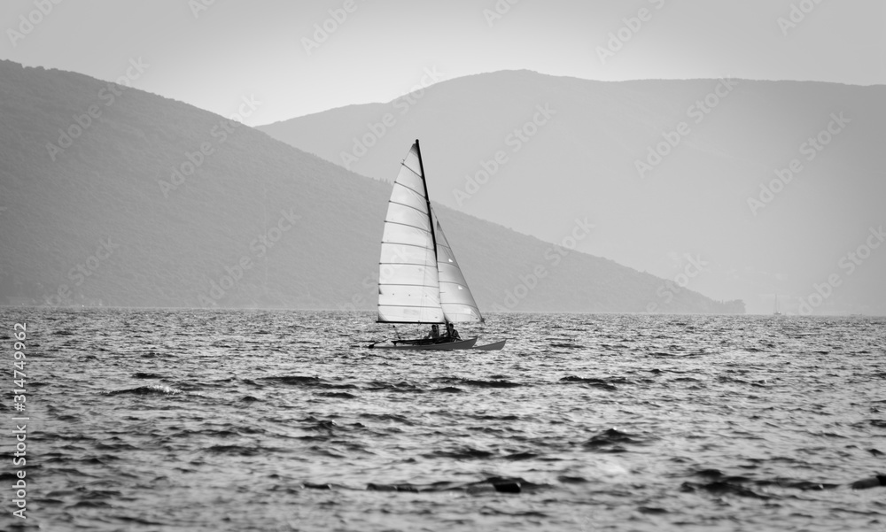 Sailboat on the sea with island in background
