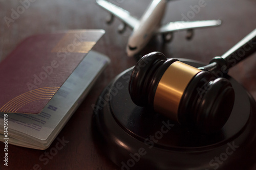 Judge's gavel, airplane and passport. Concept of international law, immigration law and citizenship rights