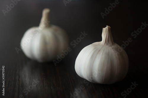 two garlics close-up isolated on a wooden background