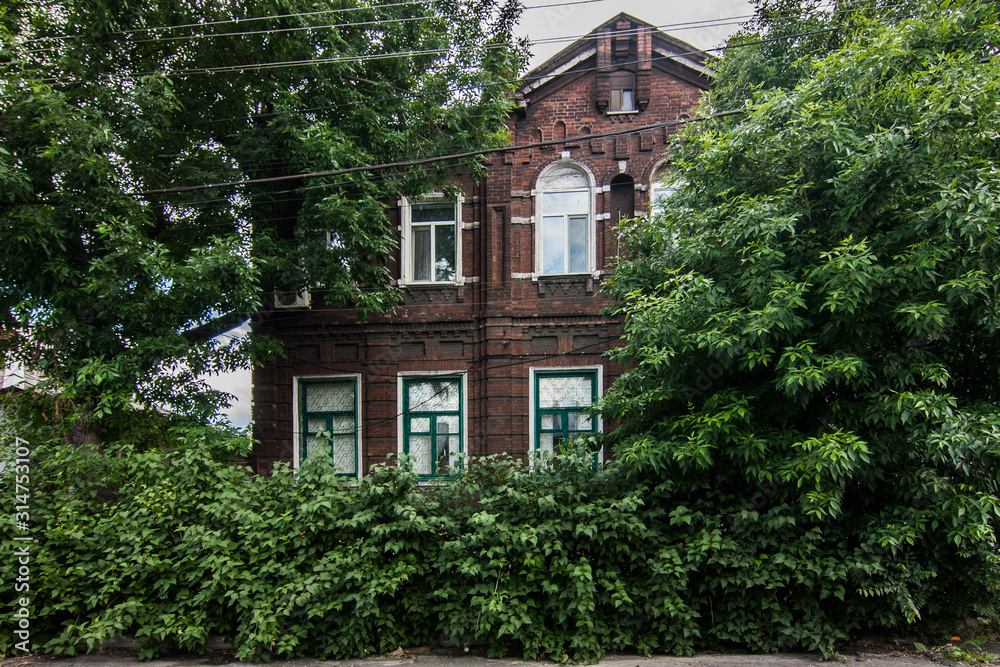 Old brick house with garden in Mariupol, Ukraine