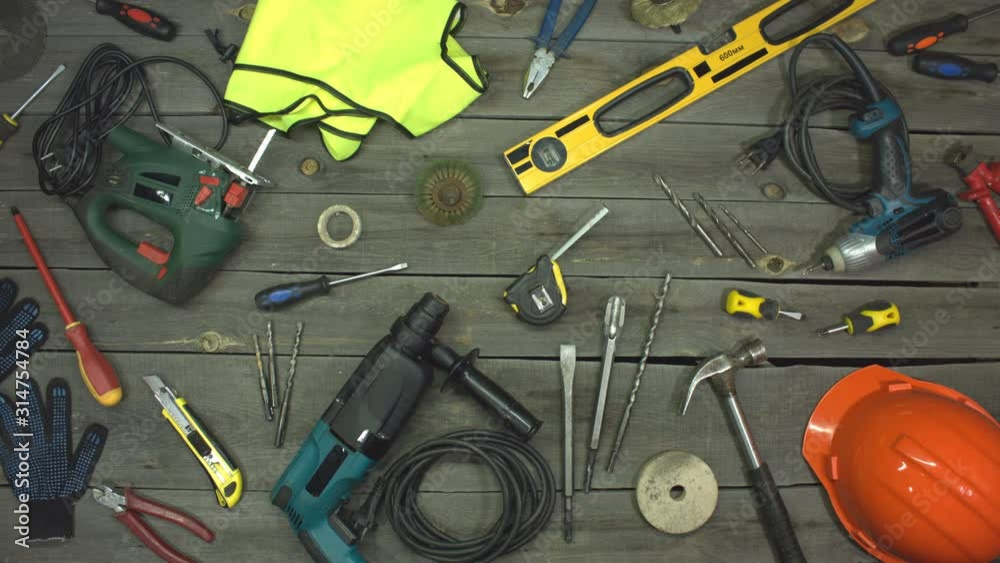 The friendship of two small yellow screwdrivers. Stop motion animation. Top view.  On the table are tools for various types of construction and repair work on wood, metal, concrete, plastic and other.