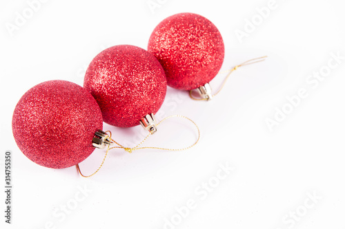 Red sparkling christmas balls on white background