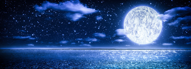 Romantic Moon With Clouds And Starry Sky Over Sparkling Blue Water